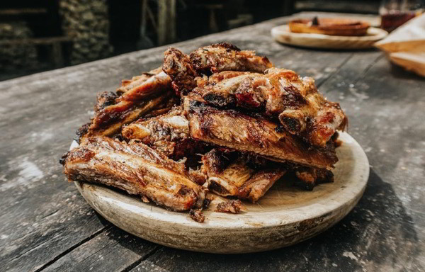 grilled pork ribs on brown wooden tray