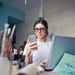 Facebook Small Business Grants Program woman in white shirt using smartphone