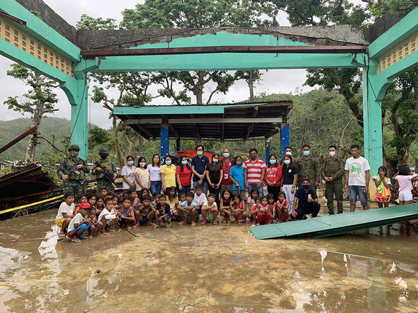 Teachers and students of Dugui 2 Elementary School in Virac, Catanduanes, together with representatives from Ayala Foundation, the Philippine Army, the Philippine Navy, as well as community residents
