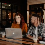 get the right help man and woman sitting in front of silver macbook