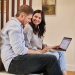 CLM contract lifecycle management man sitting beside woman looking at a contract on DocuSign