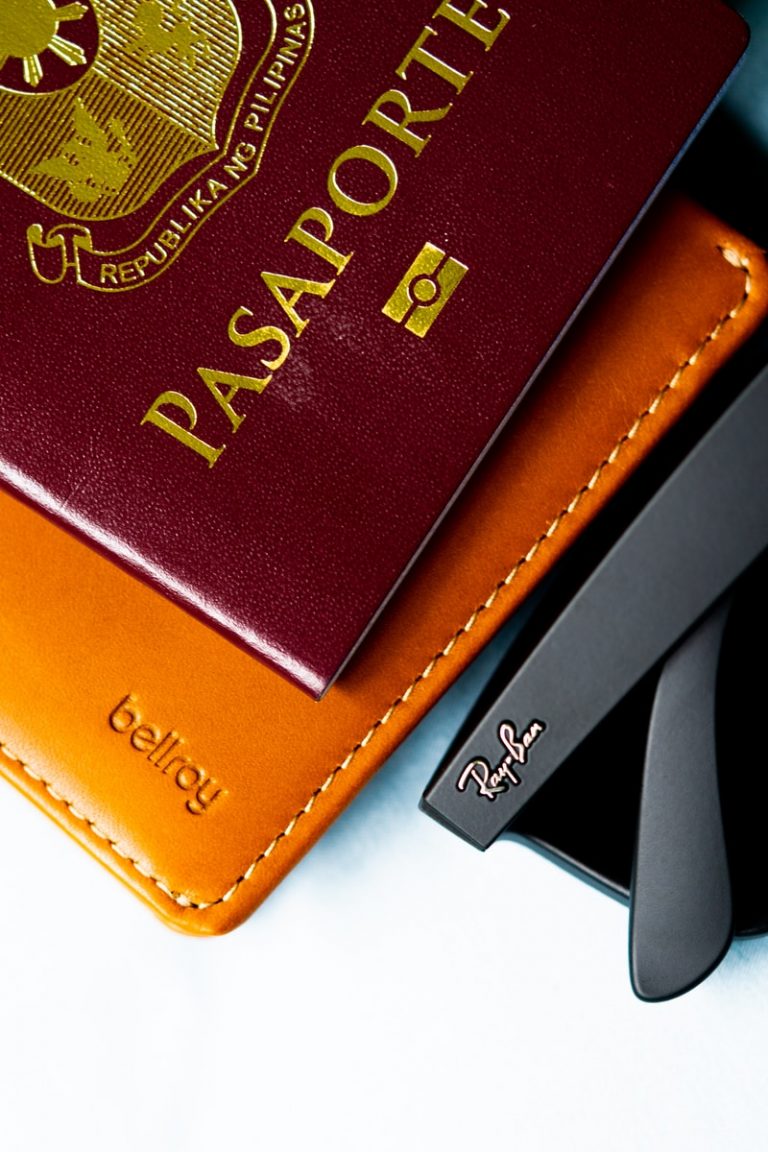 brown leather bifold wallet on white table