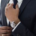 man wearing watch with black suit