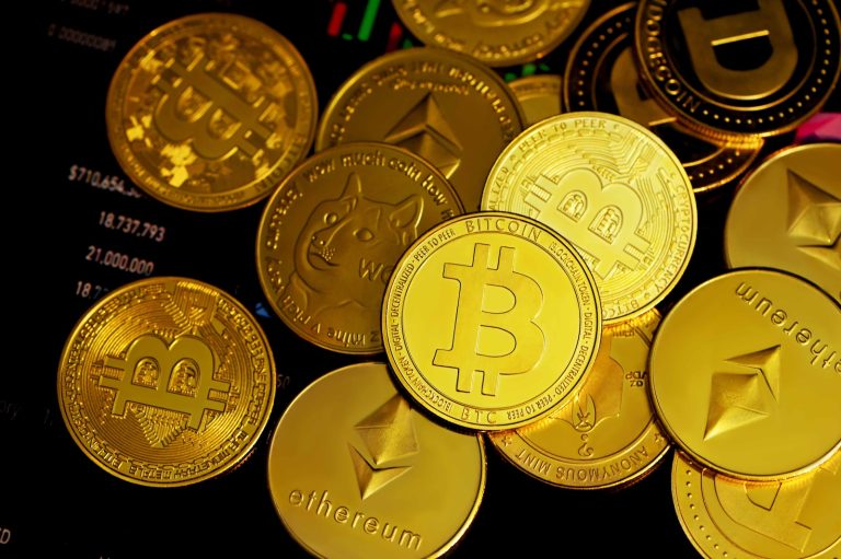 a pile of gold bitcoins sitting on top of each other