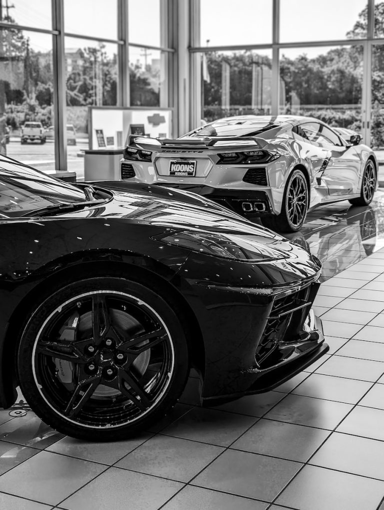 a black and white photo of two sports cars