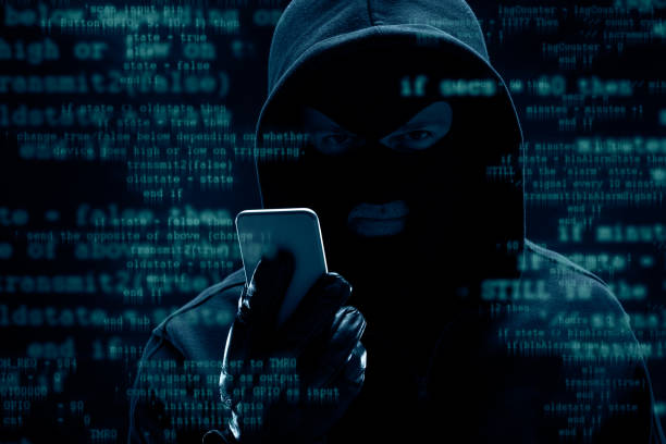 Impersonation Attacks Hacker working with smart phone. Cyber crime concept.