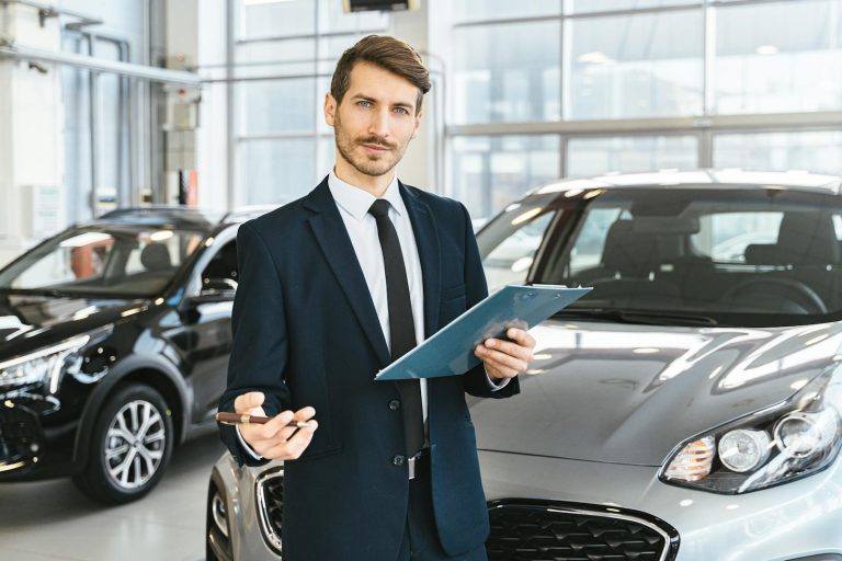 Luxury Cars- Man in Blue Business Suit Holding Blue Folder