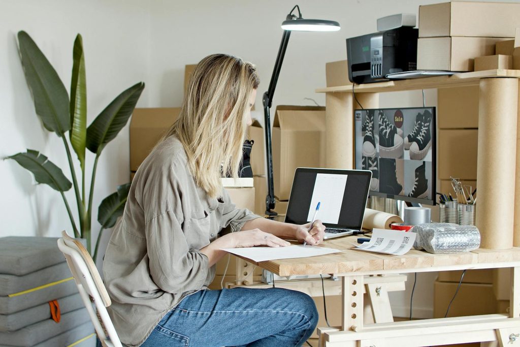 Side Hustle- Woman Busy Writing on the Paper