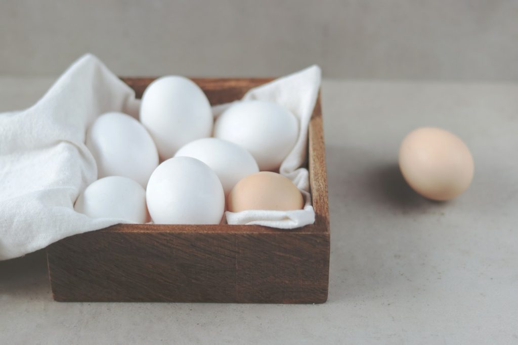 Basic Methods of Cooking Eggs 15 a wooden box filled with white and brown eggs