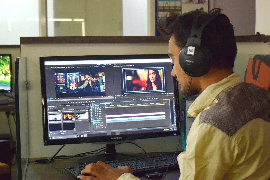 How AI Is Transforming Digital Marketing: From AI Ad Makers to Auto Post Systems and AI Video Creation 1 a man sitting in front of a computer with headphones on